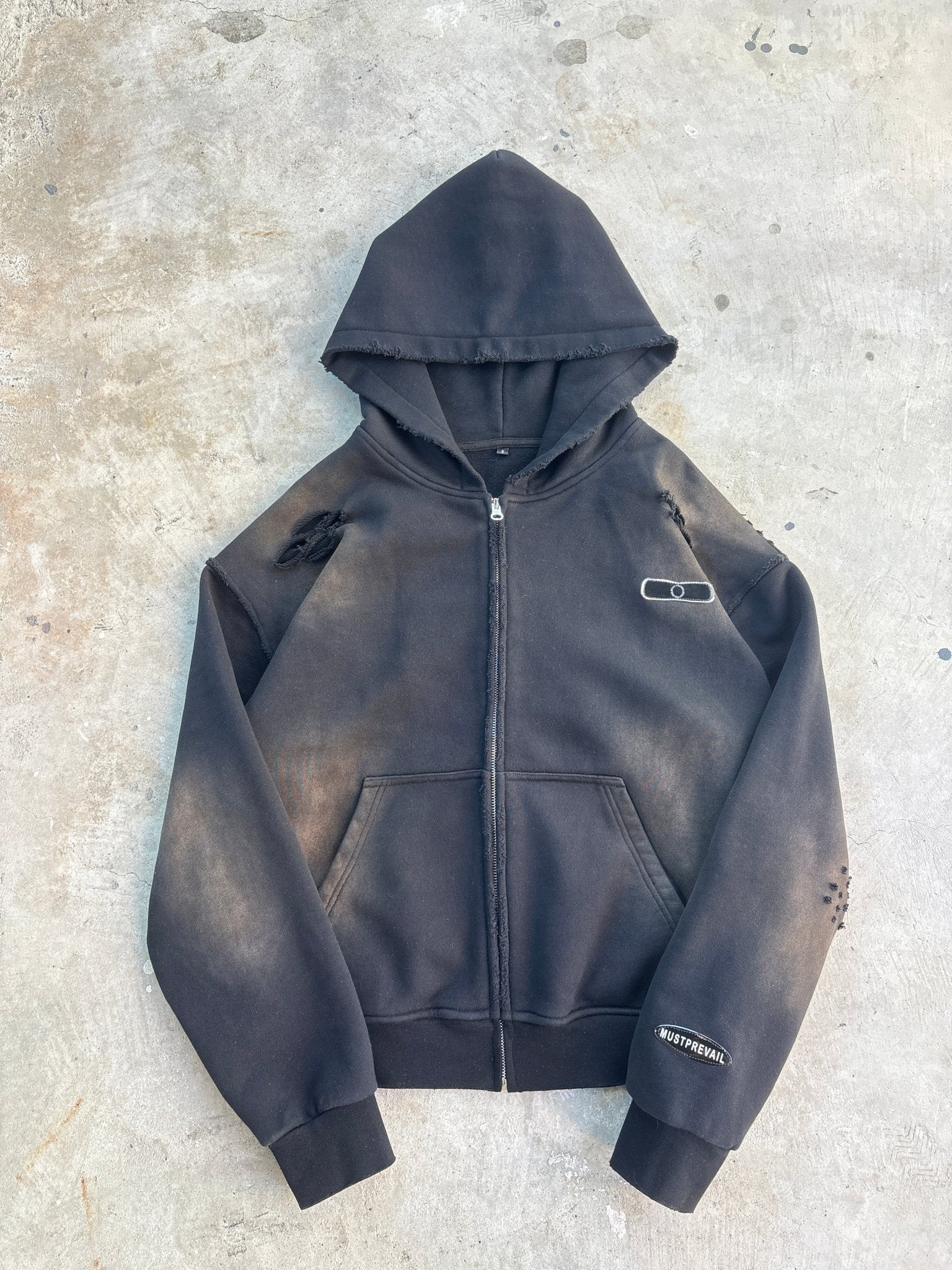 Black hoodie on a textured gray surface