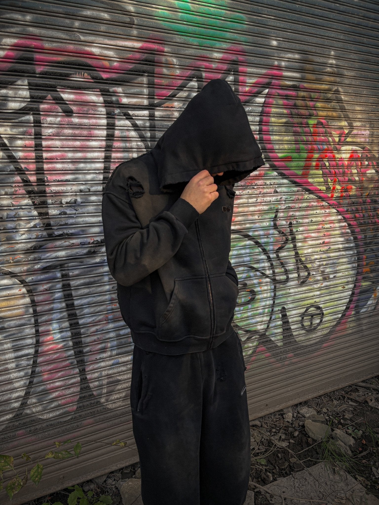 On-body silhouette of the MUST PREVAIL black 500 GSM French Terry full outfit. Showcases the cropped-drop shoulder hoodie with a deep-V hood paired with the oversized baggy triple-waistband sweatpants. The wide-leg fit and sand-blast vintage aesthetic create a structured, heavyweight Y2K-inspired streetwear silhouette.
